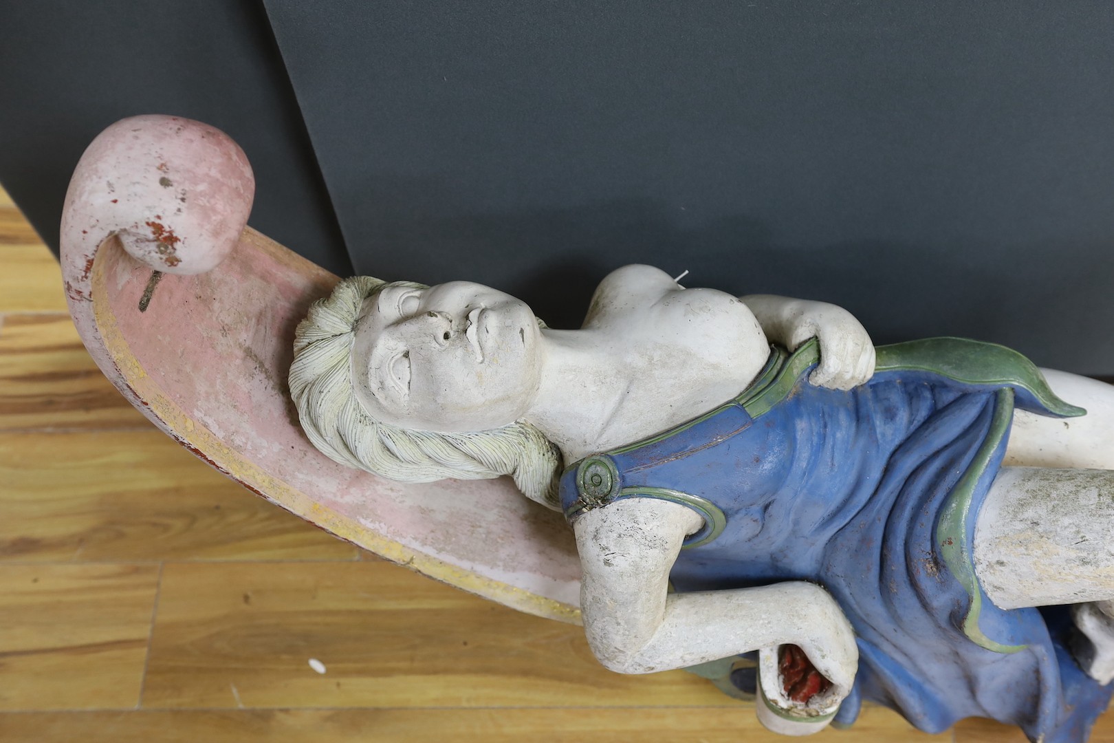 A painted wood and gesso female figurehead reclining - 74cm deep, 93cm high